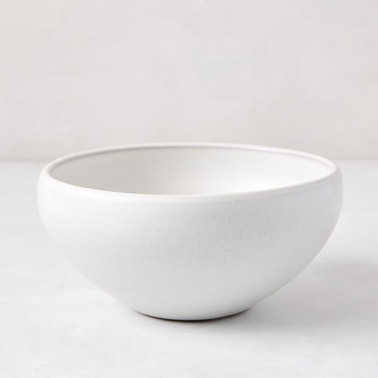 Matte white stoneware bowl with subtle grey speckles, handcrafted in Portugal.