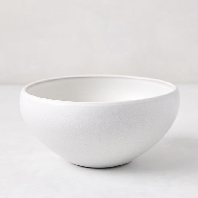 Matte white stoneware bowl with subtle grey speckles, handcrafted in Portugal.