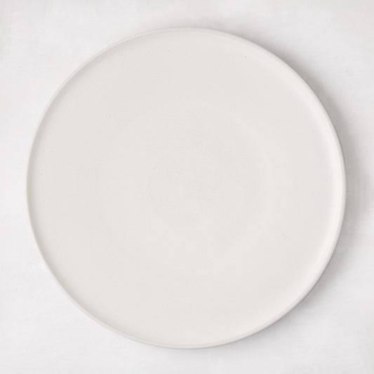 Matte white stoneware dinner plate with subtle grey speckles.