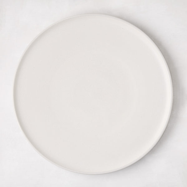 Matte white stoneware dinner plate with subtle grey speckles.