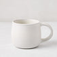 Matte white stoneware mug with a smooth glaze and subtle grey speckles, from the Matte White Stoneware Collection.