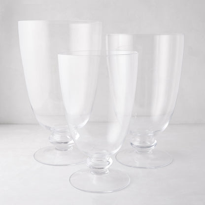 Three clear Mayfair Medium Glass Hurricanes with decorative bases, varying in height.