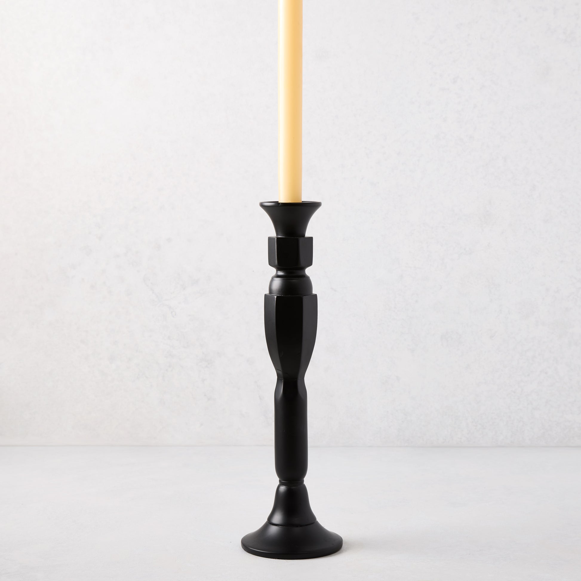 Medium black lacquer Georgian candlestick, hand-carved beechwood, 13"H, with a cream taper candle.