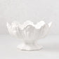 White ceramic scallop serve bowl with decorative base.