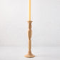 Medium natural beechwood Georgian candlestick with a cream taper candle.