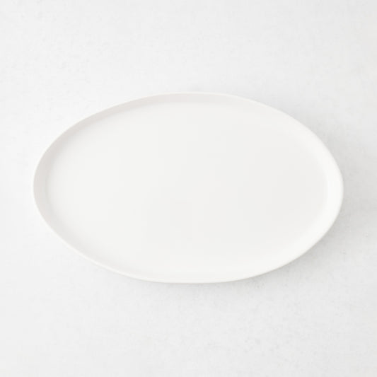 Medium oval white stoneware serving platter with a minimalist design, 15 inches long, handmade in Portugal.