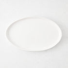 Medium oval white stoneware serving platter with a minimalist design, 15 inches long, handmade in Portugal.