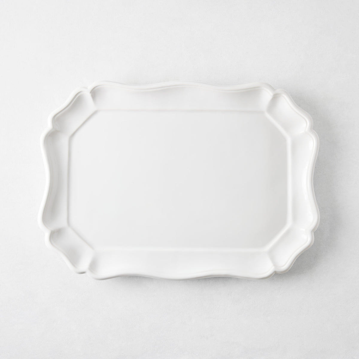 Medium 14-inch white ceramic Torcello serve platter with a scalloped edge, made in Italy.