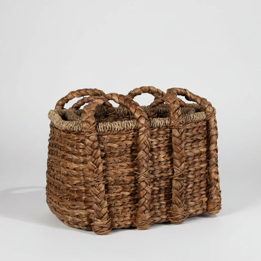 Medium woven brown water hyacinth basket with double braided handles.