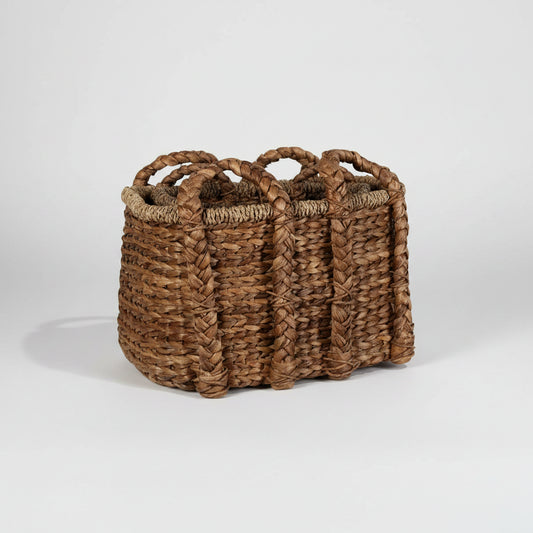 Woven basket with handles on a white background