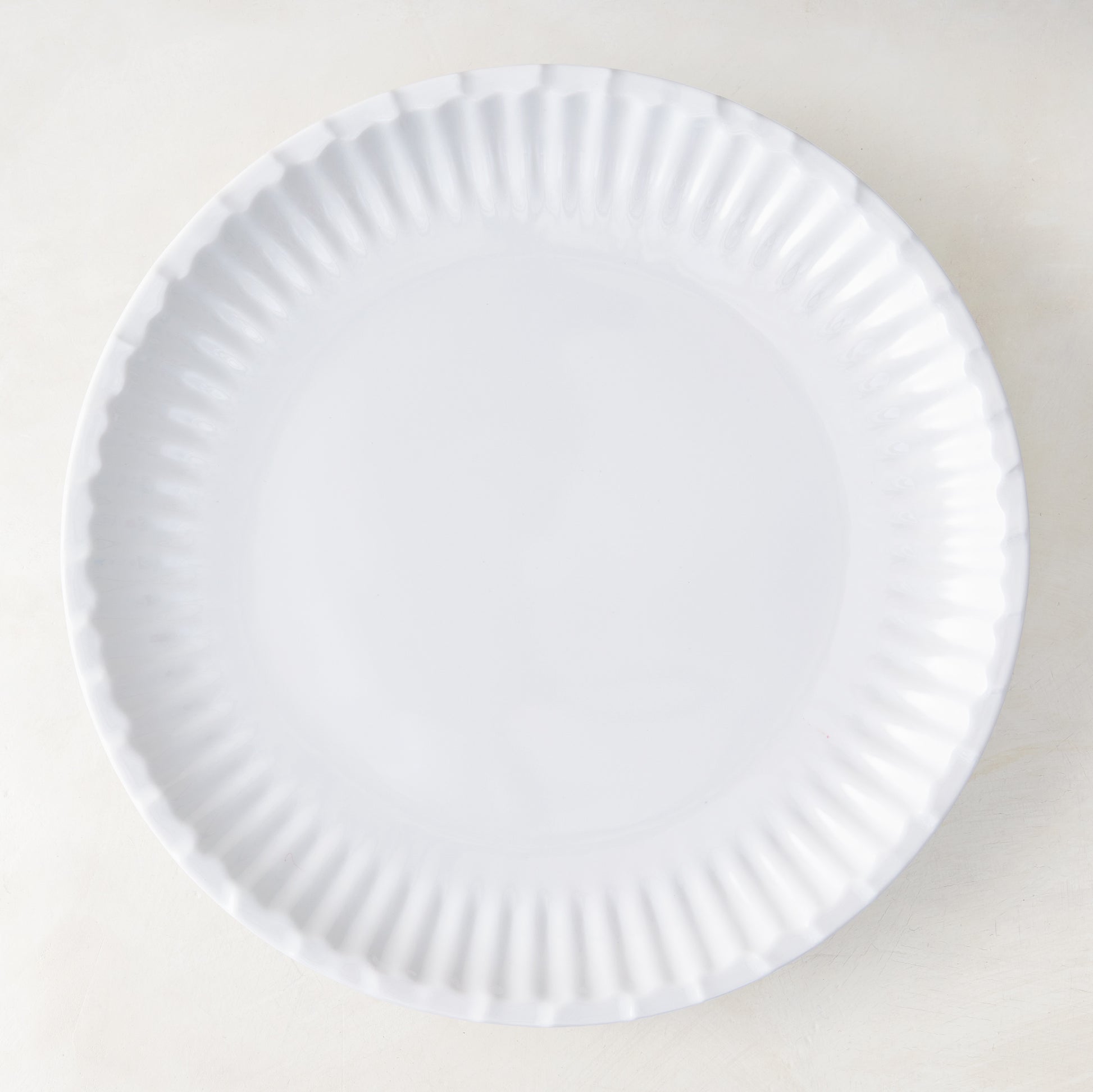 White 10.5" Melamine Street Eats dinner plate with a fluted edge, mimicking a paper plate.