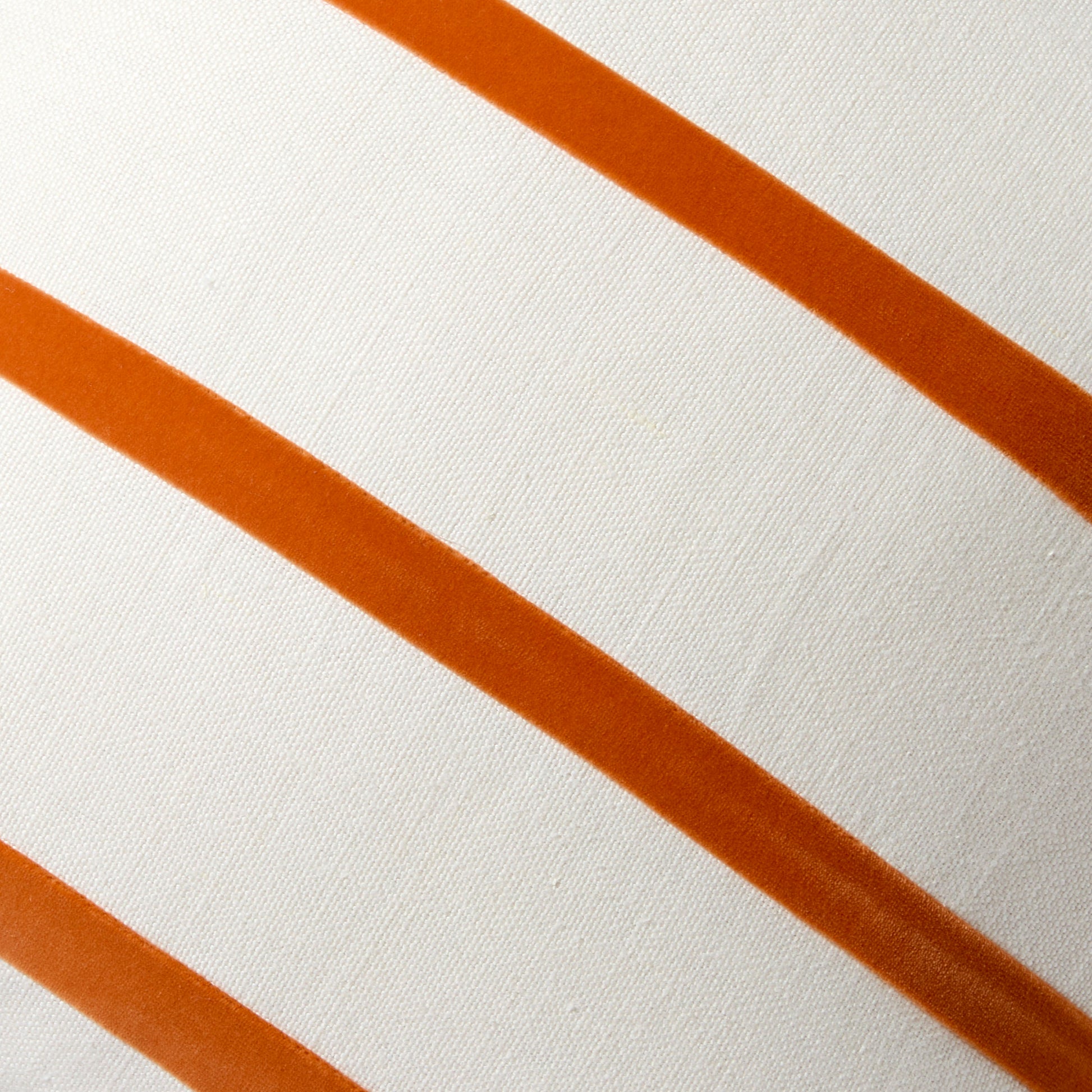 Melon orange velvet stripes on an ivory linen square pillow.