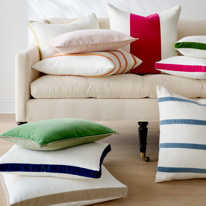 Sun yellow velvet gusseted lumbar pillow on a cream sofa with other colorful velvet and linen pillows.