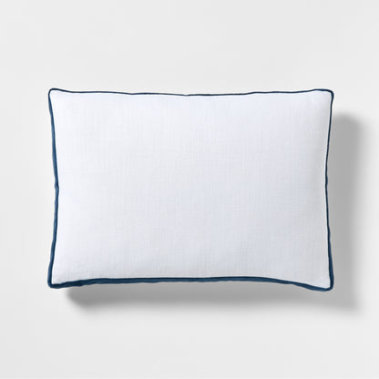 White linen lumbar pillow with midnight blue velvet gusset and piping.