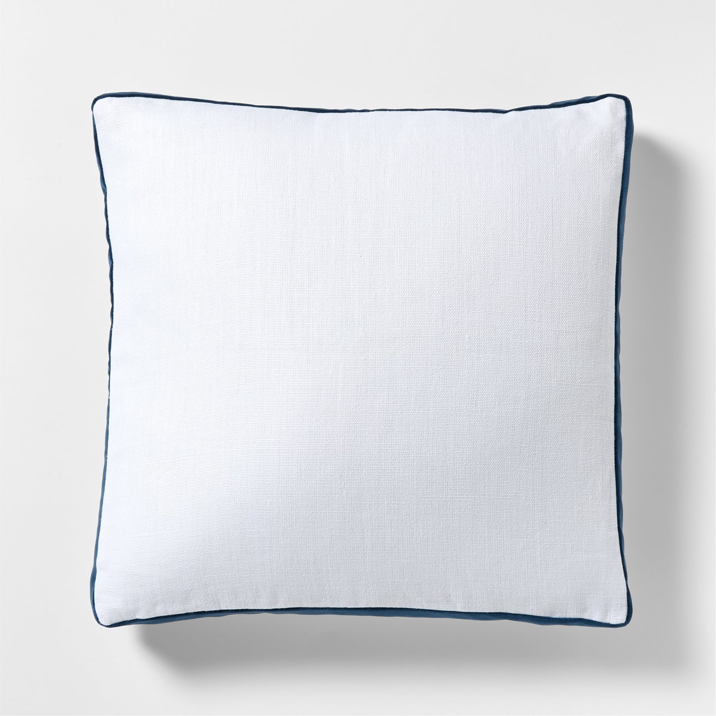 White linen square pillow with midnight blue velvet gusset and piping.