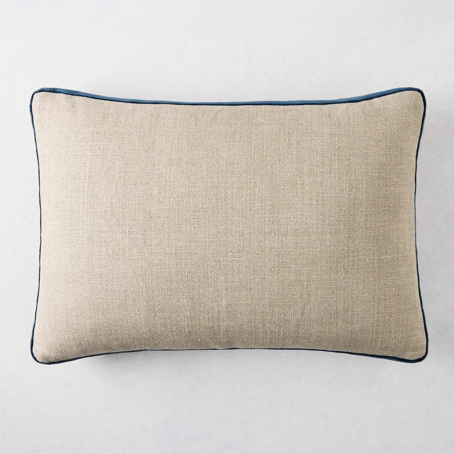 Linen lumbar pillow with midnight blue velvet gusset, 20"L x 14"H.