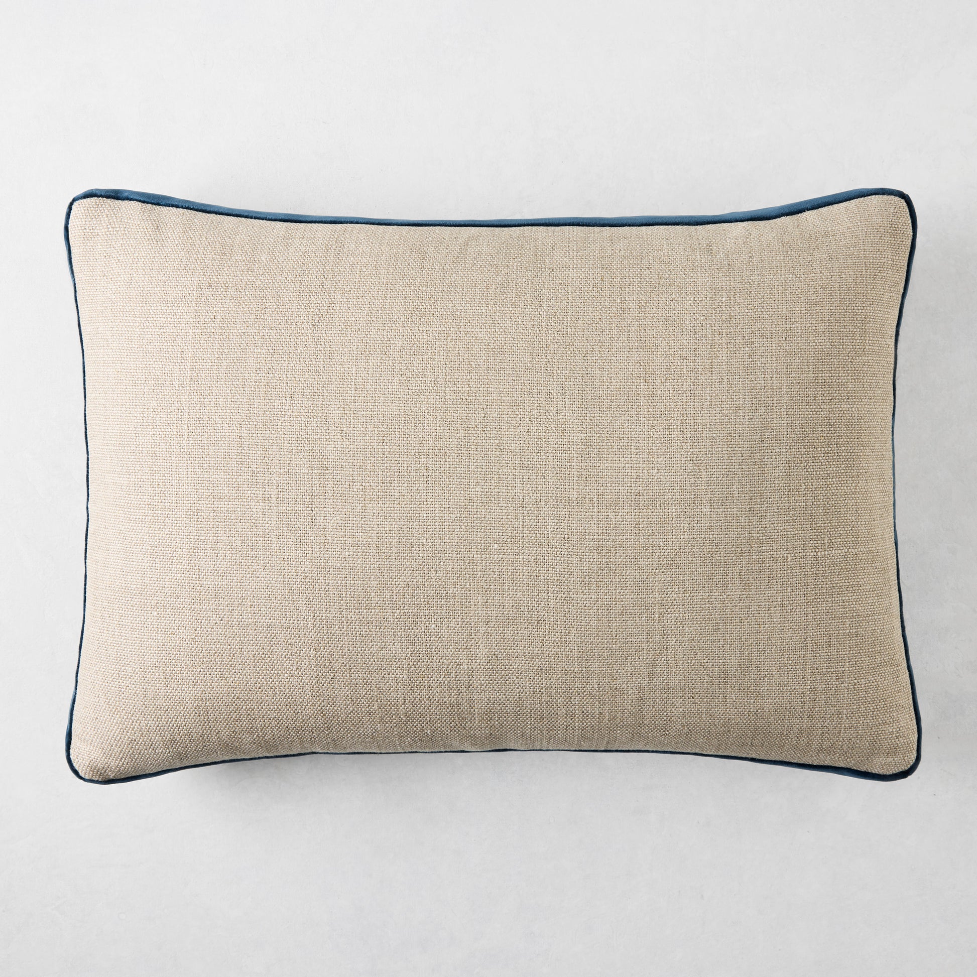 Linen lumbar pillow with midnight blue velvet gusset, 20"L x 14"H.