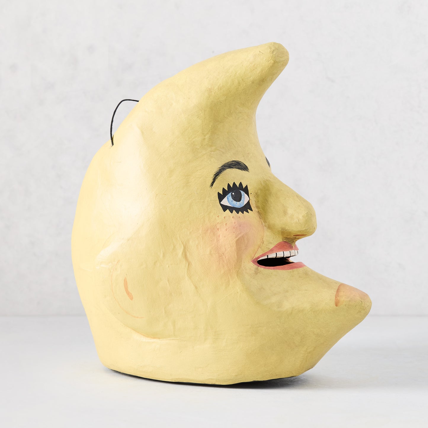 Handcrafted yellow papier-mâché Man in the Moon Halloween candy bucket with a vintage distressed finish.