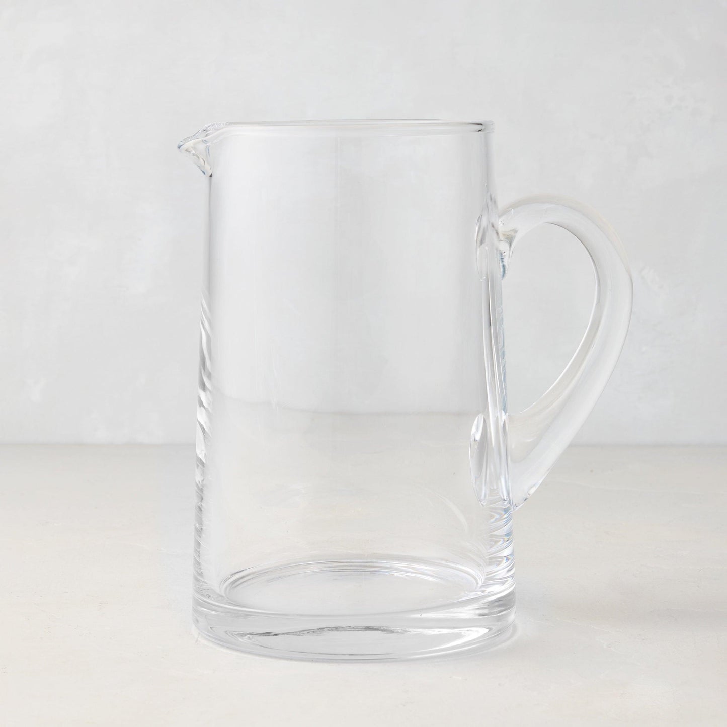 Midtown Tapered Glass Pitcher, clear, sleek design, with a handle and pour spout.