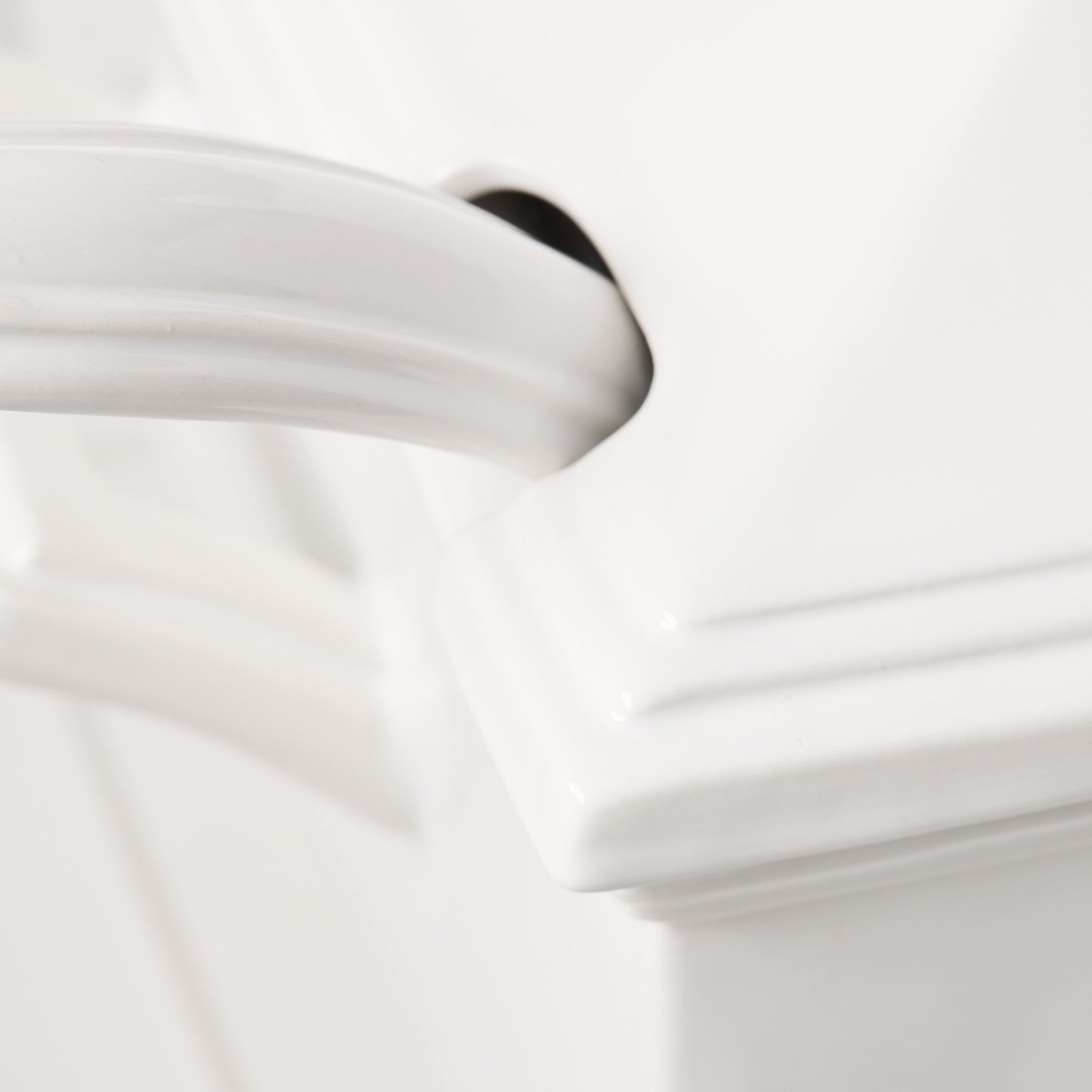 Close-up of a white ceramic Milano soup tureen handle with a classic, elegant design.