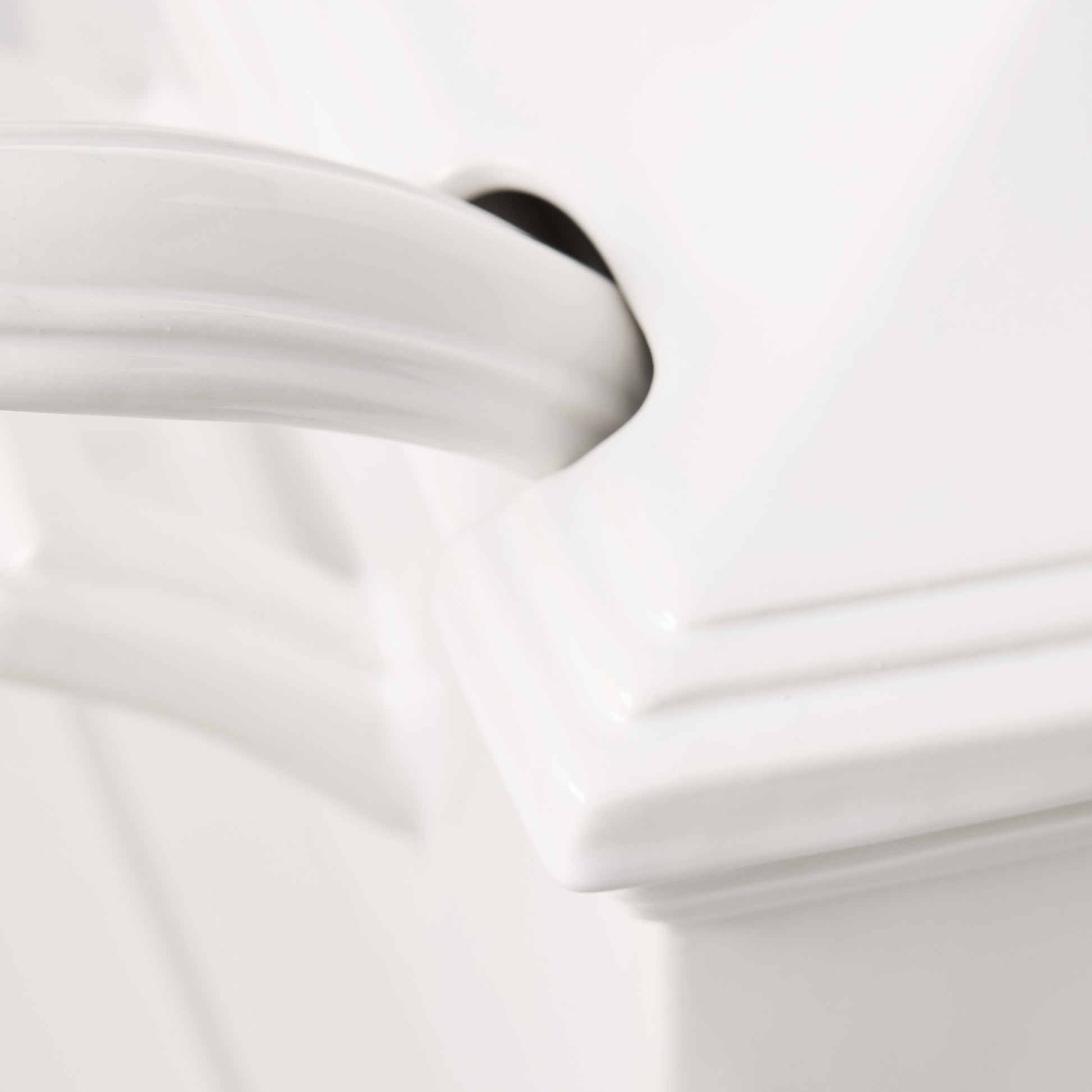 Close-up of a white ceramic Milano soup tureen handle with a classic, elegant design.