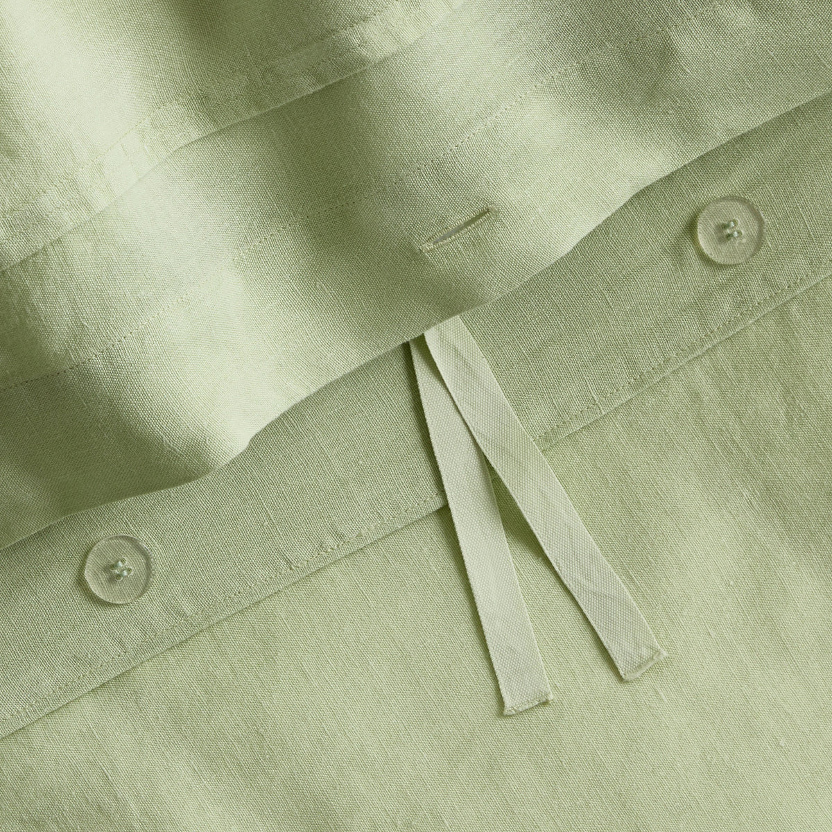 Mint green European washed linen duvet cover with button closures and fabric ties in a soft, textured finish.