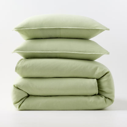 Stacked mint green European washed linen duvet cover and two matching pillow shams on a white background.