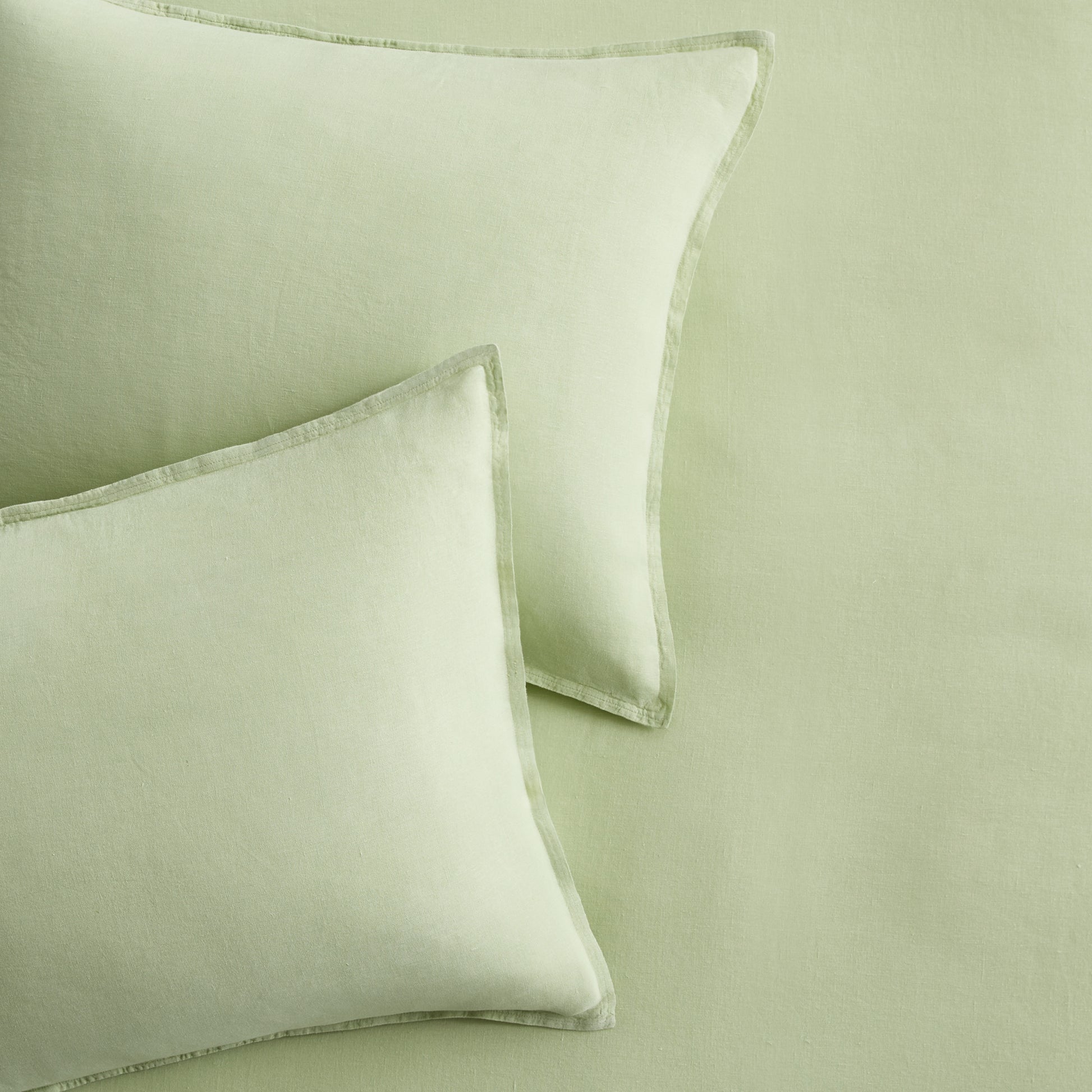Set of two mint green European washed linen euro shams with a soft, textured finish and flange border detail.
