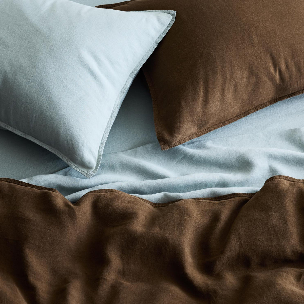Mist blue and brown washed linen duvet cover and shams set with a relaxed, textured finish.