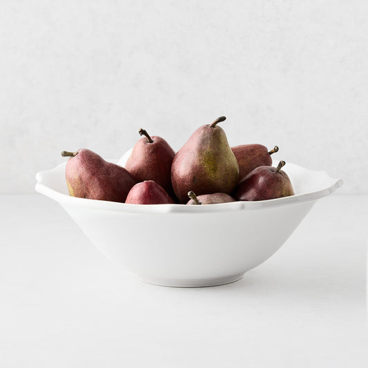 Large white ceramic Lungarno serve bowl filled with red pears, featuring soft edges and a glossy glaze finish.