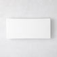 Modern rectangular white ceramic serving platter, 14.75"L x 6.75"W, with clean lines and low profile.