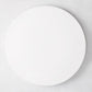 Modern round white ceramic serving platter, 14.5" diameter, smooth edgeless surface.