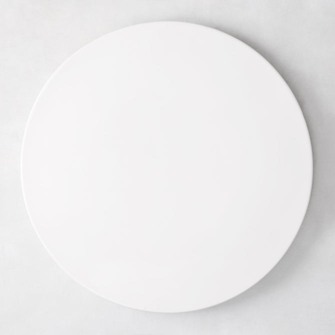 Modern round white ceramic serving platter, 14.5" diameter, smooth edgeless surface.