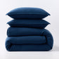 Stacked moonlight blue European washed linen duvet and two matching pillow shams on a white background.