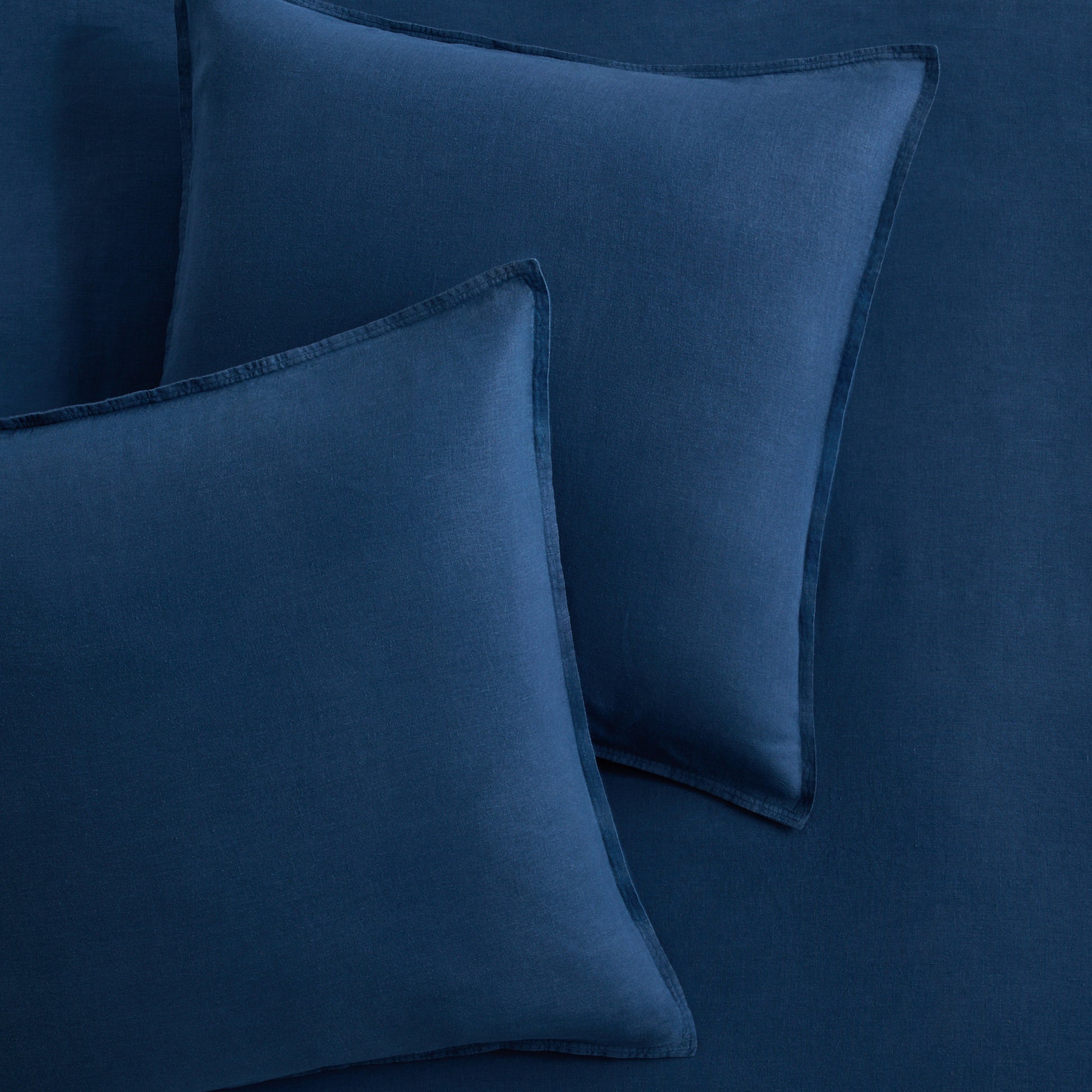 Set of two square Moonlight Blue European washed linen euro shams with flange edges.