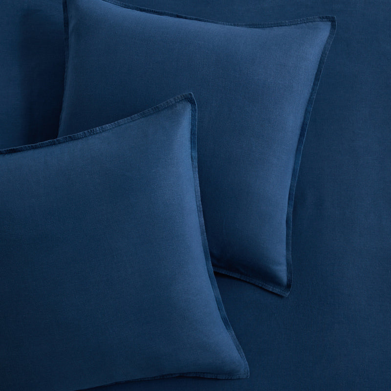 Set of two square Moonlight Blue European washed linen euro shams with flange edges.