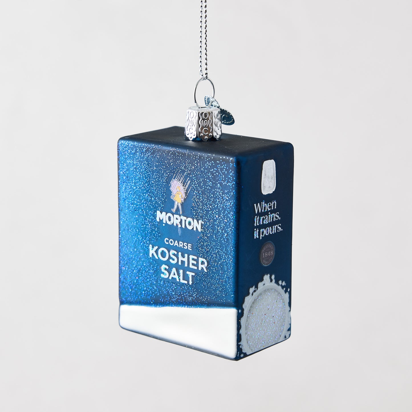 Glittery blue Morton Coarse Kosher Salt box Christmas ornament made of glass and resin with hand-painted details.