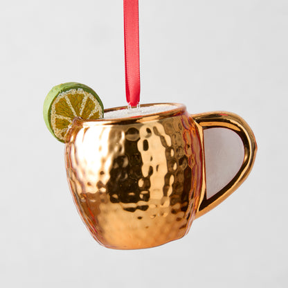 Hand-painted glass Moscow Mule ornament, copper mug with hammered texture, lime slice, red ribbon.