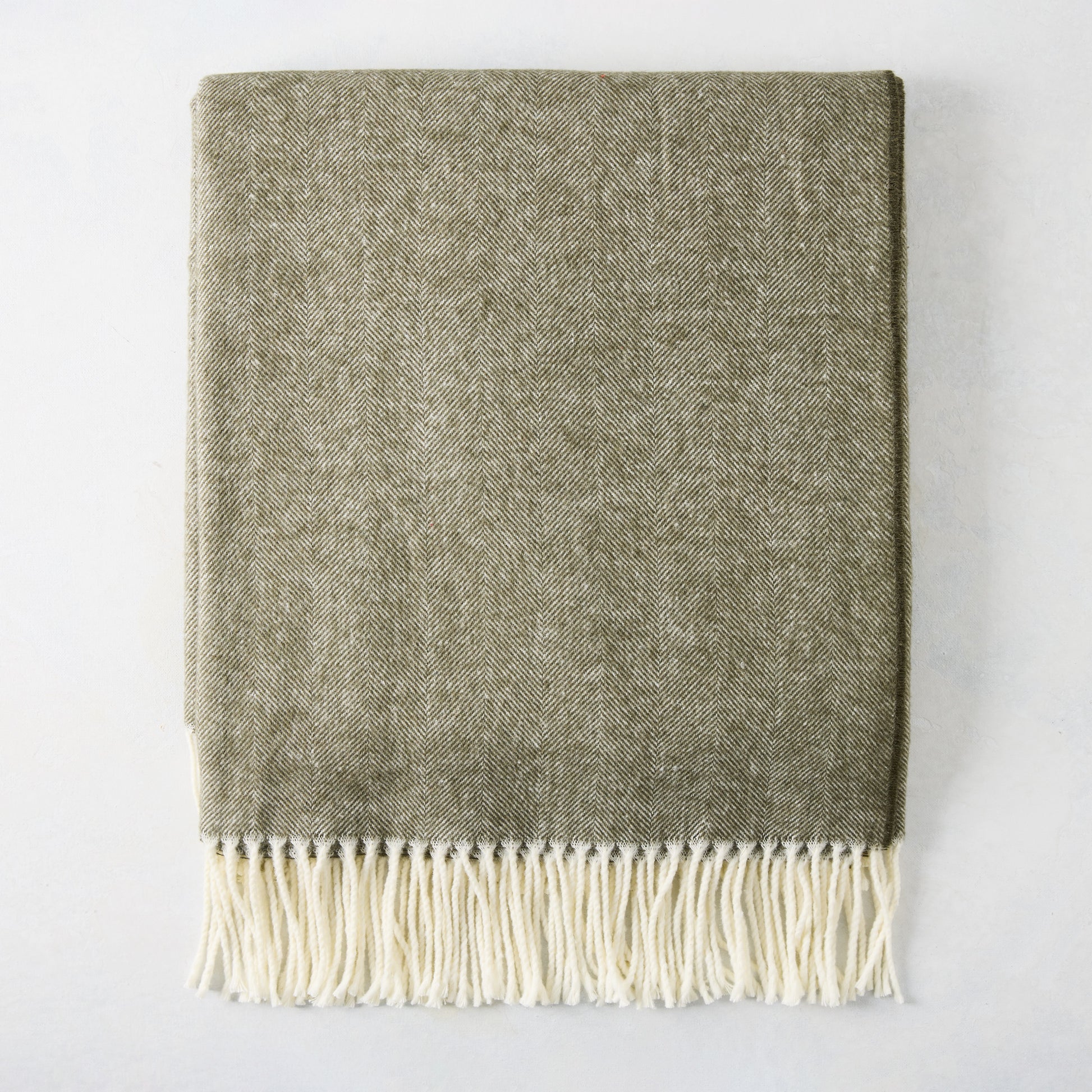 Moss Green Italian Herringbone Throw Blanket, 51"x67" cotton-acrylic blend with cream fringe.