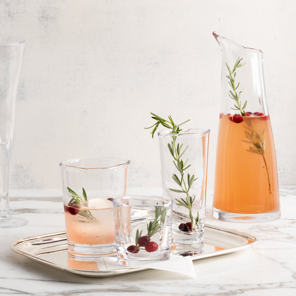 Clear Mozes Scissor-Cut Water Glass, 10.5 oz, with a rippled rim, alongside other drinkware.