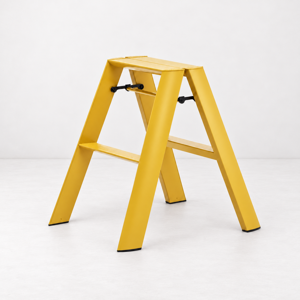 Mustard yellow Hasegawa Lucano 2-step ladder in aluminum and steel with a minimalist design and black safety latches.