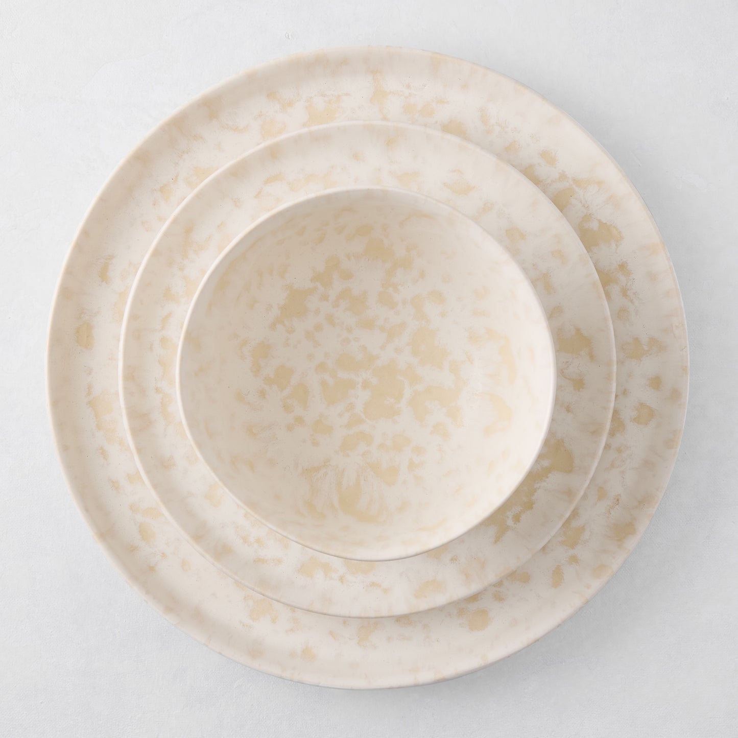 Natural Nuno Splatter Stoneware Bowl, 6"Dia x 3"H, with beige spots on a pale cream base.
