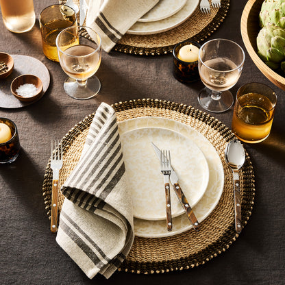 Natural Nuno Splatter 11" stoneware dinner plate with unique beige spots on a pale cream base.