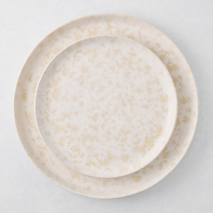 Natural Nuno Splatter 11" stoneware dinner plate with unique beige spots on a pale cream base.
