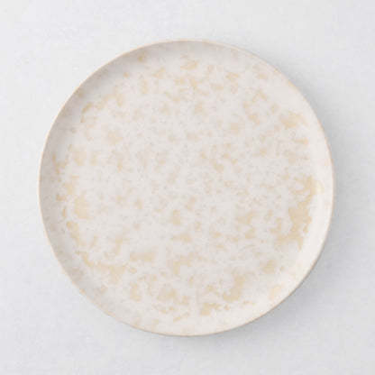 Natural Nuno Splatter 8.25" stoneware salad plate with pale cream base and beige splatter.