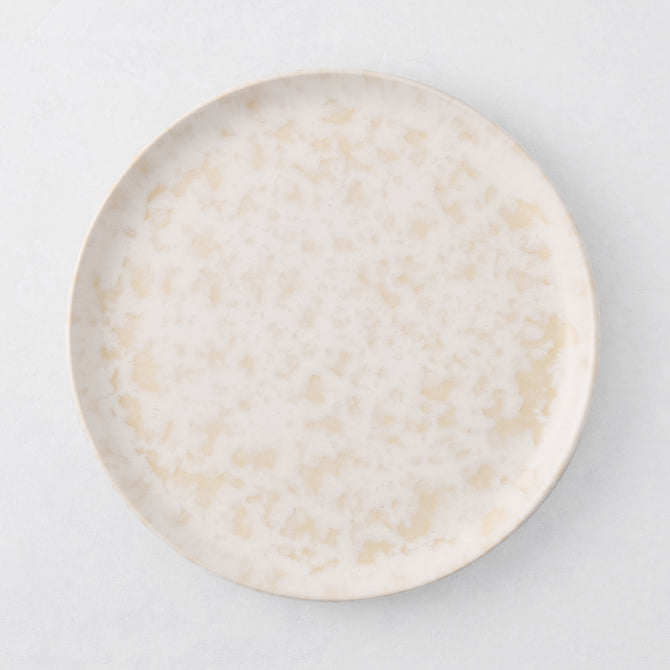 Natural Nuno Splatter 8.25" stoneware salad plate with pale cream base and beige splatter.