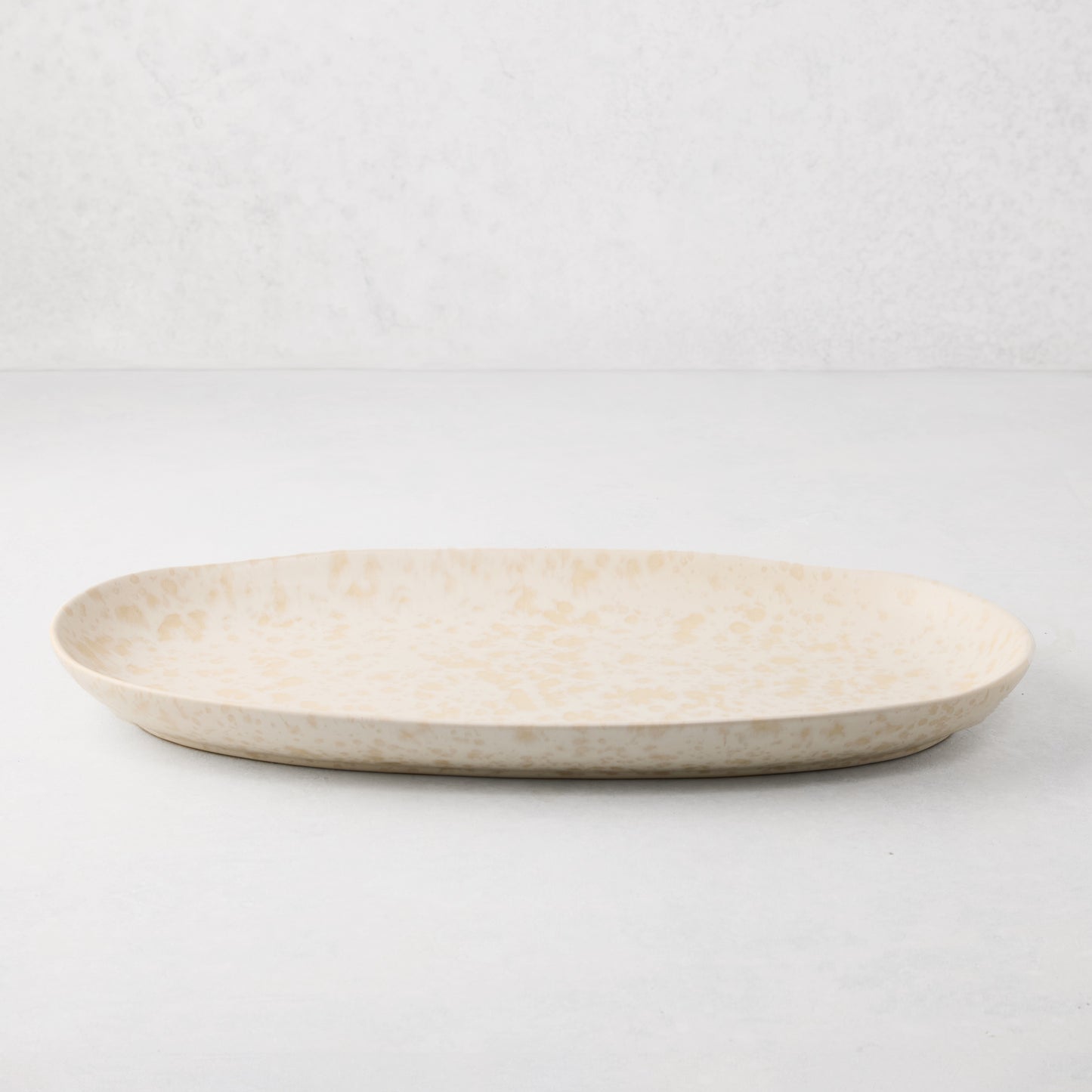 Natural Nuno Splatter Stoneware Serving Platter, 17" oval, pale cream with beige splatter.