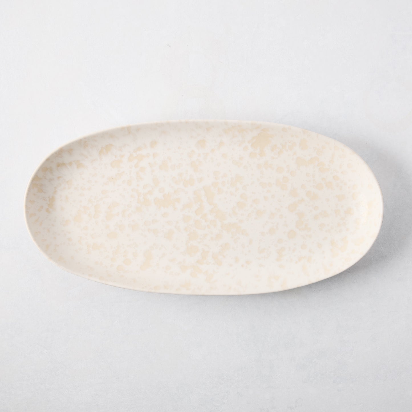 Natural Nuno Splatter Stoneware Serving Platter, pale cream with beige splatter design, 17"L x 8.25"W.