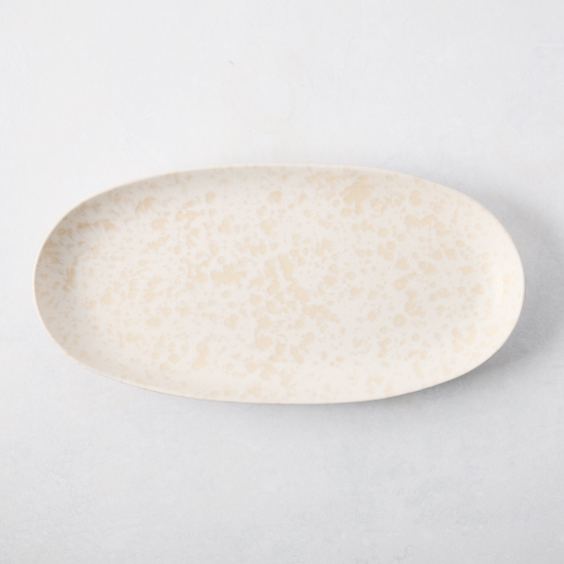 Natural Nuno Splatter Stoneware Serving Platter, pale cream with beige splatter design, 17"L x 8.25"W.