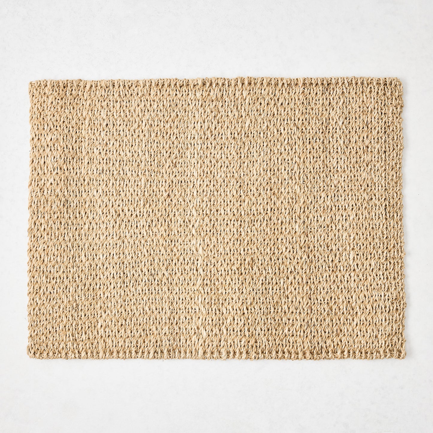 Rectangular natural woven abaca placemat in a honey-brown hue, 19"L x 14"W.